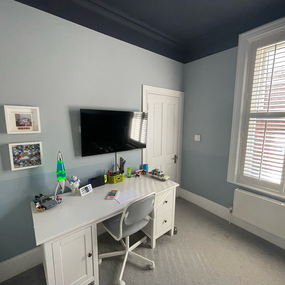 Child's bedroom with grey-blue walls and ceiling in Lie-in by COAT Paints, with white desk
